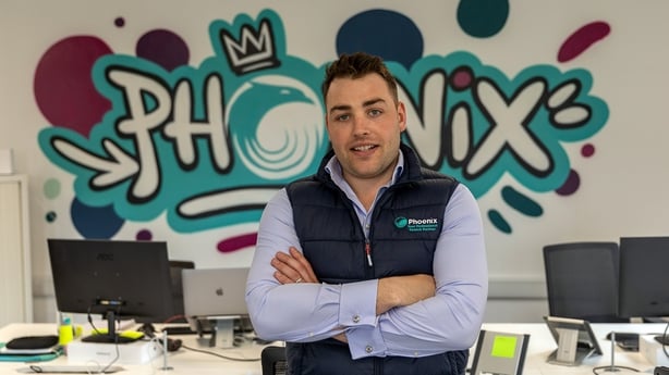 Ed Rossiter CEO of Phoenix in the Office in front of Logo Graffiti art 